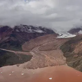 Iron rich glacier runoff to sea shore Qaanaaq island -  Greenland